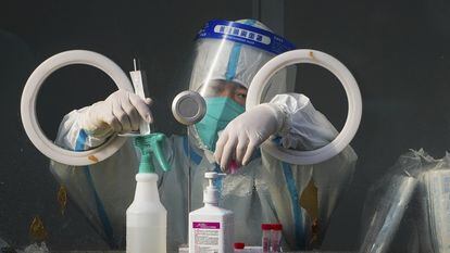 A medical worker in protective gear prepares Covid tests in Xichen district, Beijing, China.