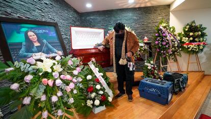 A friend pays his final respects to murdered journalist Lourdes Maldonado who was shot dead in her car when arriving home, in Tijuana, Mexico, Jan. 27, 2022.