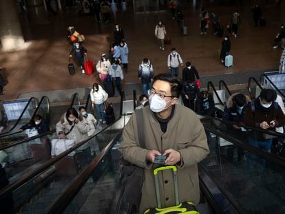 Travelers ride escalators at Beijing West Railway Station in Beijing, Wednesday, Jan. 18, 2023.