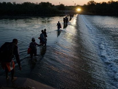 A group of Haitian migrants crosses the Rio Bravo in search of food and supplies near the Del Rio-Acuña border crossing in Acuña, Mexico.