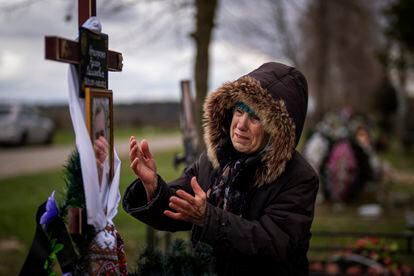 Valentyna Nechyporenko mourns at the grave of her 47-year-old son Ruslan, during his funeral at the cemetery in Bucha, on the outskirts of Kyiv, April 18, 2022.