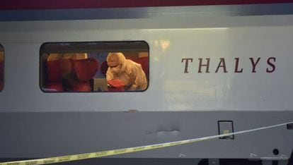 Police inspect the train carriage in which the attack took place.
