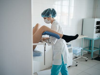 A gynecologist examines a patient.