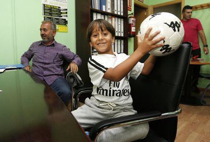 There was a global public outcry over images of Osama Abdul Mohsen, a Syrian refugee, falling to the ground with a child in his arms after a Hungarian reporter tripped him up in front of the cameras. It was this scene that motivated Miguel Ángel Galán, president of the National Soccer Coach Training Center (Cenafe), to help Abdul Mohsen move to Spain. The Syrian man arrived in Madrid on Wednesday night with two of his children, Zaid, 7 and Mohammed, 18. On Thursday, they spent their first day in Getafe, their new home, where they visited Cenafe headquarters. Pictured is Zaid with a soccer ball he had just received as a present.