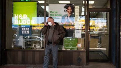 A man waits outside a H&R Block tax preparation office on Monday, April 6, 2020, in the Brooklyn borough of New York. Tax season is here again.