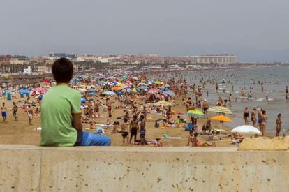 Holidaymakers on the beach at Malvarrosa, Valencia. The region is one of the most popular for tourists.