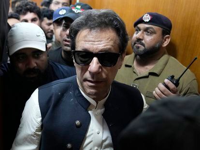 Former Pakistani Prime Minister Imran Khan, center, leaves after appearing in a court, in Lahore, Pakistan, Friday, May 19, 2023.
