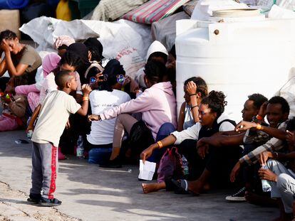 Migrants rescued at sea wait, after disembarking from a vessel, on the Sicilian island of Lampedusa, Italy, on September 18, 2023.