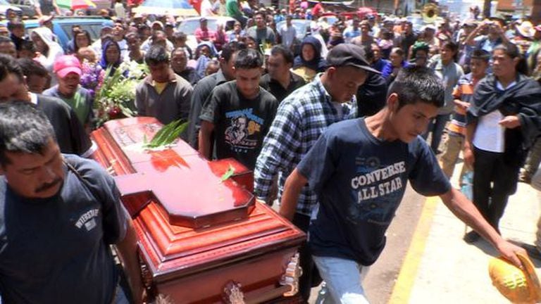 Relatives last month bury a victim of a skirmish between residents in Michoacán state.