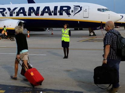Passengers board a Ryanair flight at London Stansted.