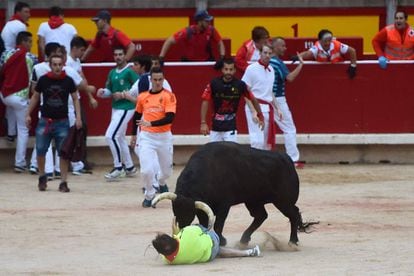 A reveller is tossed by a Jandilla fighting bull in the bullring after the seventh bullrun of the San Fermin festival in Pamplona.