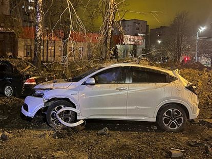 A handout photo made available by the Governor of the Belgorod Region Vyacheslav Gladkov's telegram channel shows damaged cars near the blast crater in downtown Belgorod, Russia, 20 April 2023.