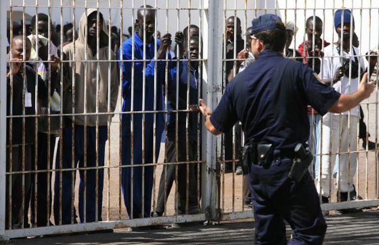 A policeman with immigrants in an internment center in the Canary Islands.