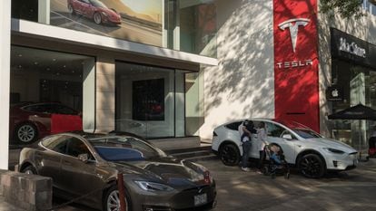 Customers look at a Tesla vehicle at a store in Mexico City.
