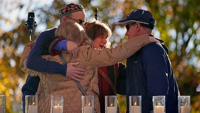 People hug after lighting a candle in memory of one of 11 worshippers killed four years ago when a gunman opened fire at the Tree of Life synagogue in Squirrel Hill, in Pittsburgh