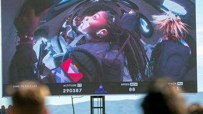 Guests watch a live broadcast from inside Virgin Galactic's rocket-powered plane Unity 22, showing space tourists Anastatia Mayers, 18, and her mother Keisha Schahaff, rear, at Spaceport America, near Truth or Consequences, N.M., Thursday, Aug. 10, 2023.