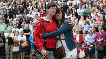Two women embrace during the funeral mass for the 79 victims in Santiago de Compostela on Monday.