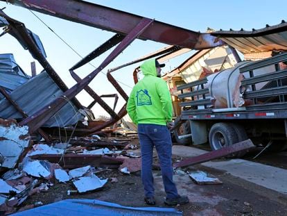 Patrick Crull tours the damage surrounding his home and farm on North Tolles Road with his family Friday morning, Feb. 9, 2024, after a confirmed tornado went through the area just northwest of Evansville, Wis., the evening before.