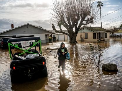 Brenda Ortega, 15, salvages items from her flooded Merced, Calif., home on Tuesday, Jan. 10, 2023.