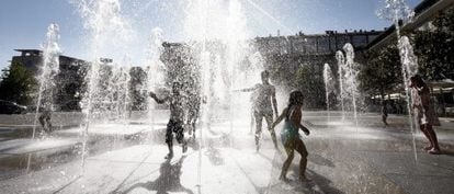 Youngsters play in fountains in the Yamaguchi park in Pamplona.