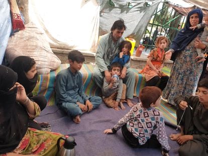 Gul Khan (left, holding her hand to her face) and members of her family at Shahr-e Now Park in Kabul, where they have been living for two months.