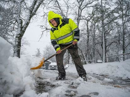 Hayes Condon shovels snow in his driveway on Tuesday, February 28, 2023, in Colfax, California.