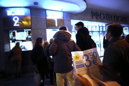 Moviegoers wait in line at a Madrid cinema on Monday.