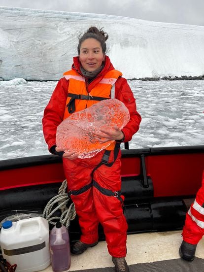 Ximena Aguilar Vega holds a block of ice during one of her expeditions in Antarctica.