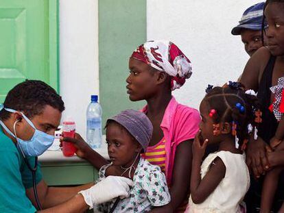 A doctor treats patients in Haiti in 2010.