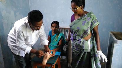 A doctor treats a leprosy patient at the Chilakalapalli hospital in Vizianagaram district, Andhra Pradesh, India in 2022.