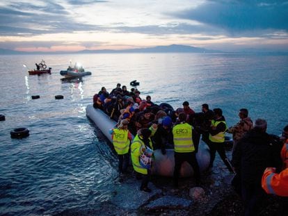 Refugees arrive in an inflatable boat from Turkey on the Greek island of Lesbos near the port city of Mitilini.