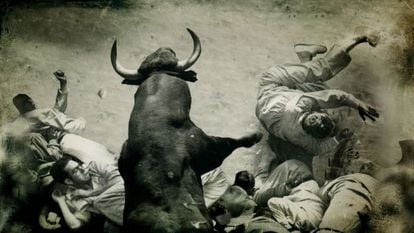 An image from the documentary of a bull colliding with a group of runners in the alley that leads into the Pamplona bullring.