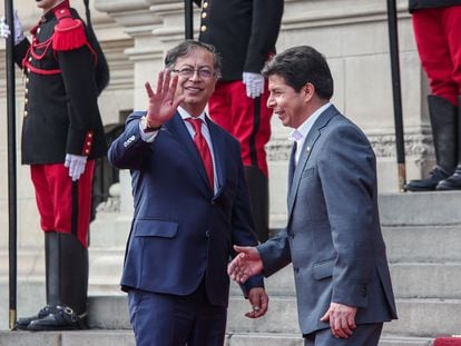 Colombian President Gustavo Petro waves to cameras alongside Pedro Castillo, during a visit to Lima in August of 2022.