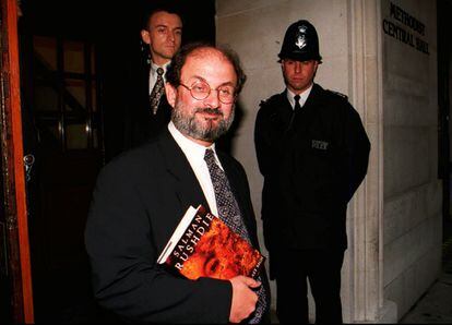 Salman Rushdie, with a copy of 'The Satanic Verses' in 1995. 