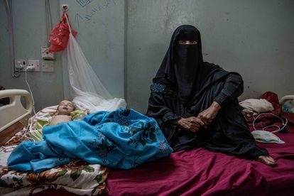 The grandmother of six-month-old Mona Basam Abdallah stays by her bedside at the public hospital in Ataq, the capital of the province of Shabwah.