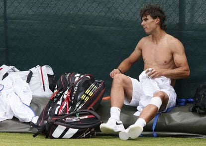 Rafael Nadal changes his shirt during a training session at Wimbledon in London on Saturday.
