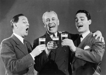 Three friends during a toast in a publicity image taken in 1950.