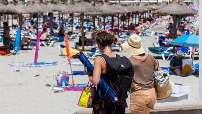 Tourists on Peguera beach, in the city of Calvià on the island of Mallorca.