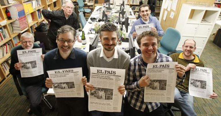 The team behind the EL PAÍS ENGLISH EDITION, pictured with the proofs of the last print issue.