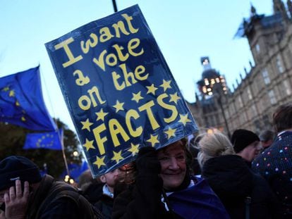 An anti-Brexit protester holds up a sign outside the Houses of Parliament in London.