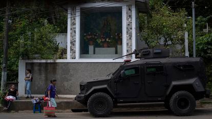 Vidalina Morales, a human rights defender, walks in front of an army vehicle in Cabañas, El Salvador, in August.