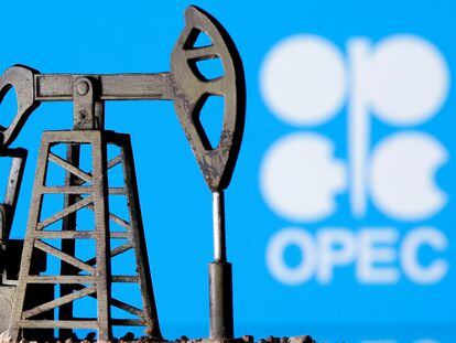 A 3D printed oil pump jack is seen in front of the OPEC logo.