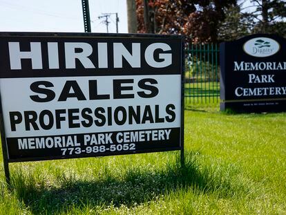 A hiring sign is displayed at a cemetery in Skokie, Illinois, on May 10, 2023.