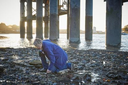 The 'mudlarker' Lara Maiklem rummaging along the banks of the Thames, in London. Photo courtesy of the publisher.