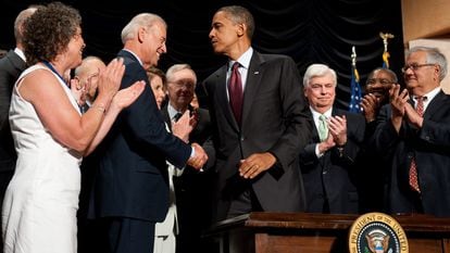 Former president Barack Obama shakes hands with current U.S. President Joe Biden in July 2010 after signing the Dodd-Frank Wall Street Reform and Consumer Protection Act.