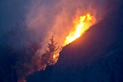 Flames are visible from the Beluga Point parking area near Anchorage, Alaska, on July 19, 2016, as a wildfire near McHugh Creek burns.