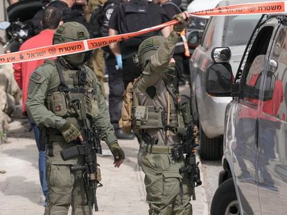 Israeli policemen secure a shooting attack site in east Jerusalem, Saturday, Jan. 28, 2023.