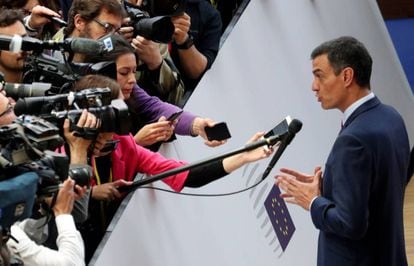 Pedro Sánchez talks to the media as he arrives at a European Union leaders summit.