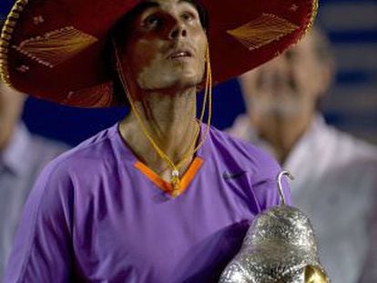 Rafael Nadal of Spain wears a traditional Mexican mariachi hat while holding the winning trophy in Acapulco.