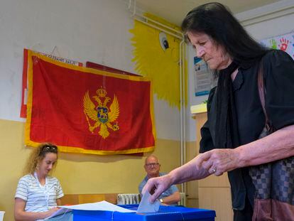 A woman casts her ballot at a polling station in Montenegro's capital Podgorica
